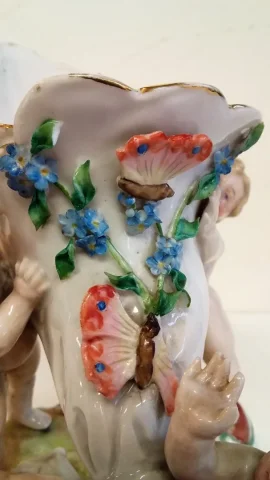 Coupe en porcelaine de Meissen polychromé représentant 3 puttis soutenant une coupe ornée d'un décor floral, Probablement XIXe siècle marque sous la base