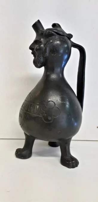Curieux Pichet en bronze reposant sur trois pieds à tête de grotesque