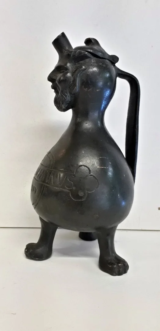 Curieux Pichet en bronze reposant sur trois pieds à tête de grotesque
