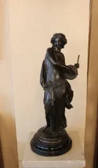 STATUE OF A TAMBOURINE PLAYER