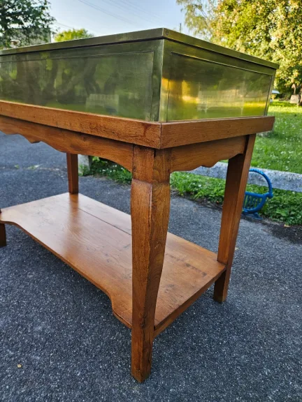 Siégel: Flat Brass Display Cabinet On Table.