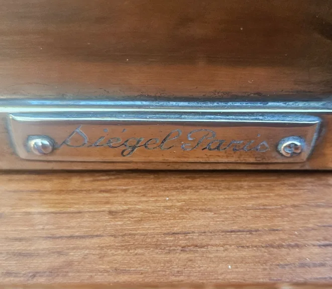Siégel: Flat Brass Display Cabinet On Table.