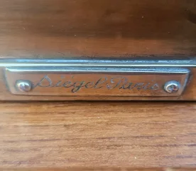 Siégel: Flat Brass Display Cabinet On Table.