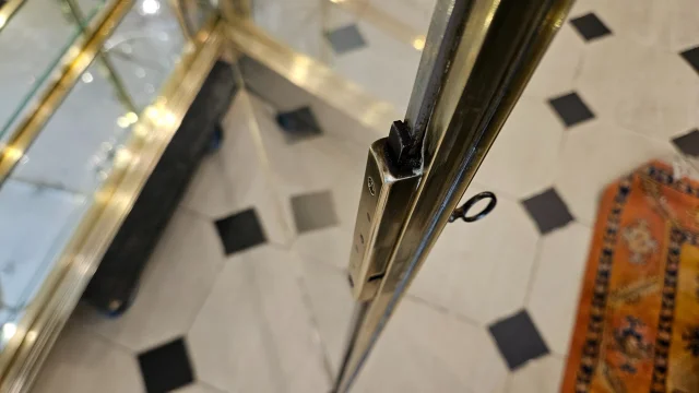 SIEGEL : Rare vitrine murale d’exposition en laiton et bronze à cotés bombés. Début du XX° siècle. — Excellent état