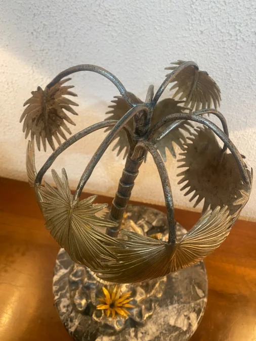 Sculpture en métal figurant un chamelier dans une oasis
