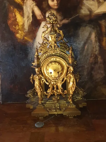 Pendule bronze doré cariatides XIX.